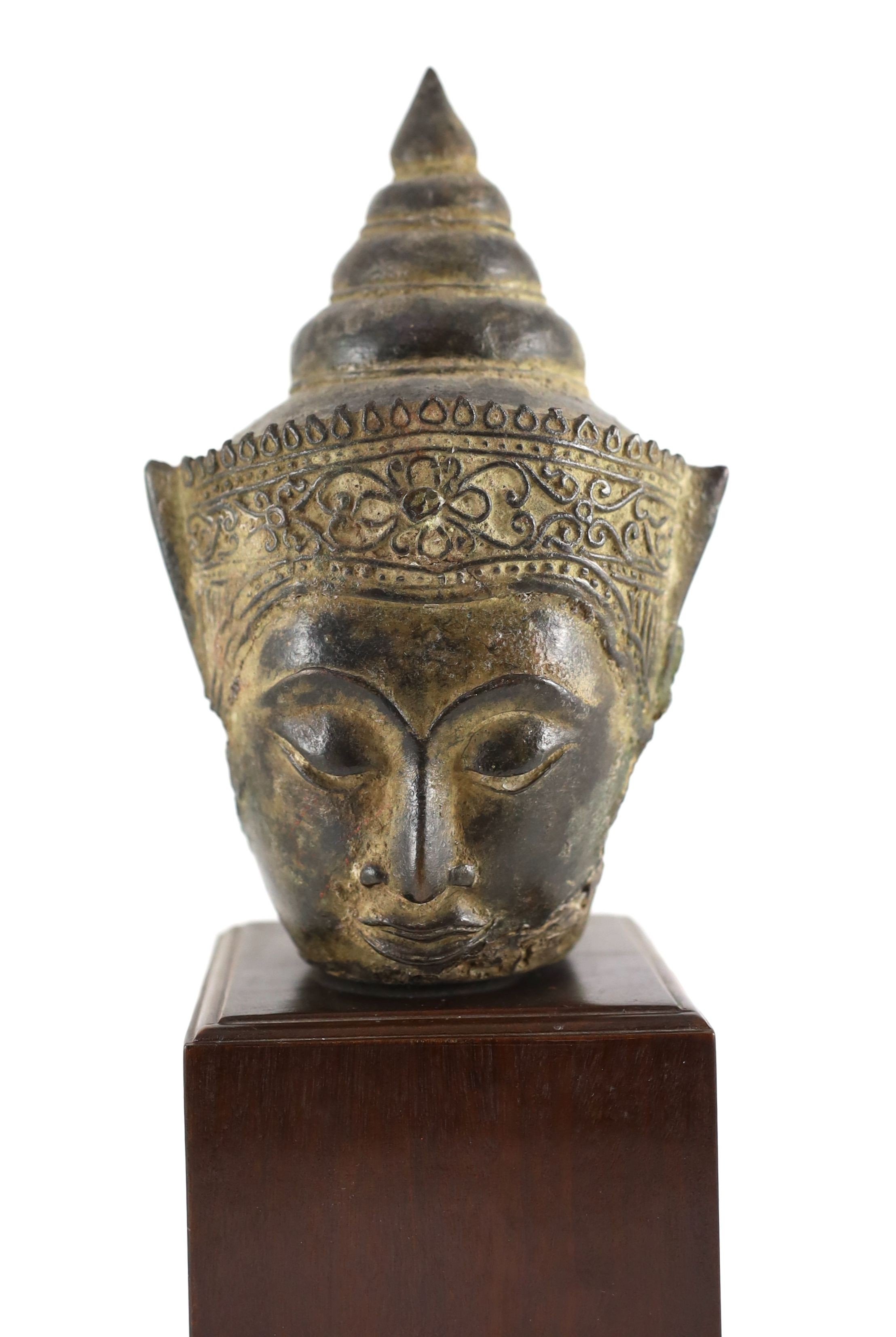 A Thai bronze crowned head of Buddha, 16th/17th century, 18cm high, excluding modern wood stand, ears lacking